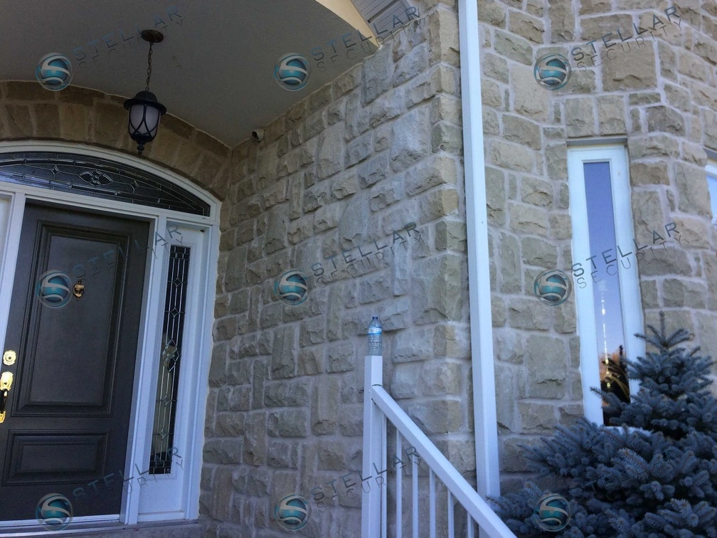 Outdoor security camera protecting front porch and main entrance door of a Cambridge home