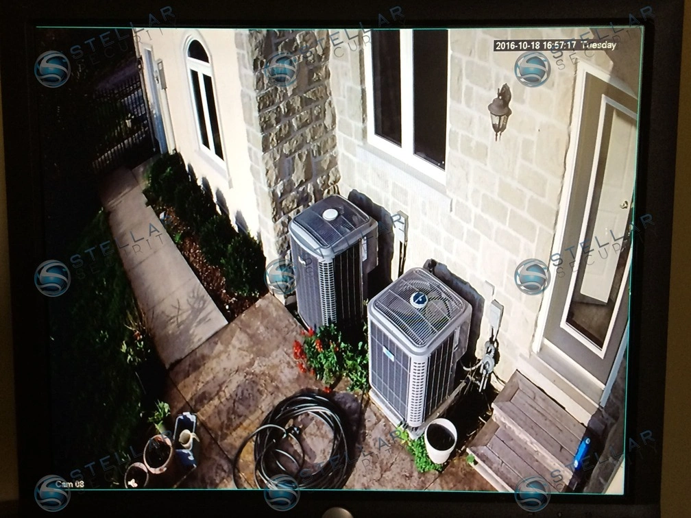 Security camera monitor feed covering side entrance walkway and AC units of a Cambridge residence