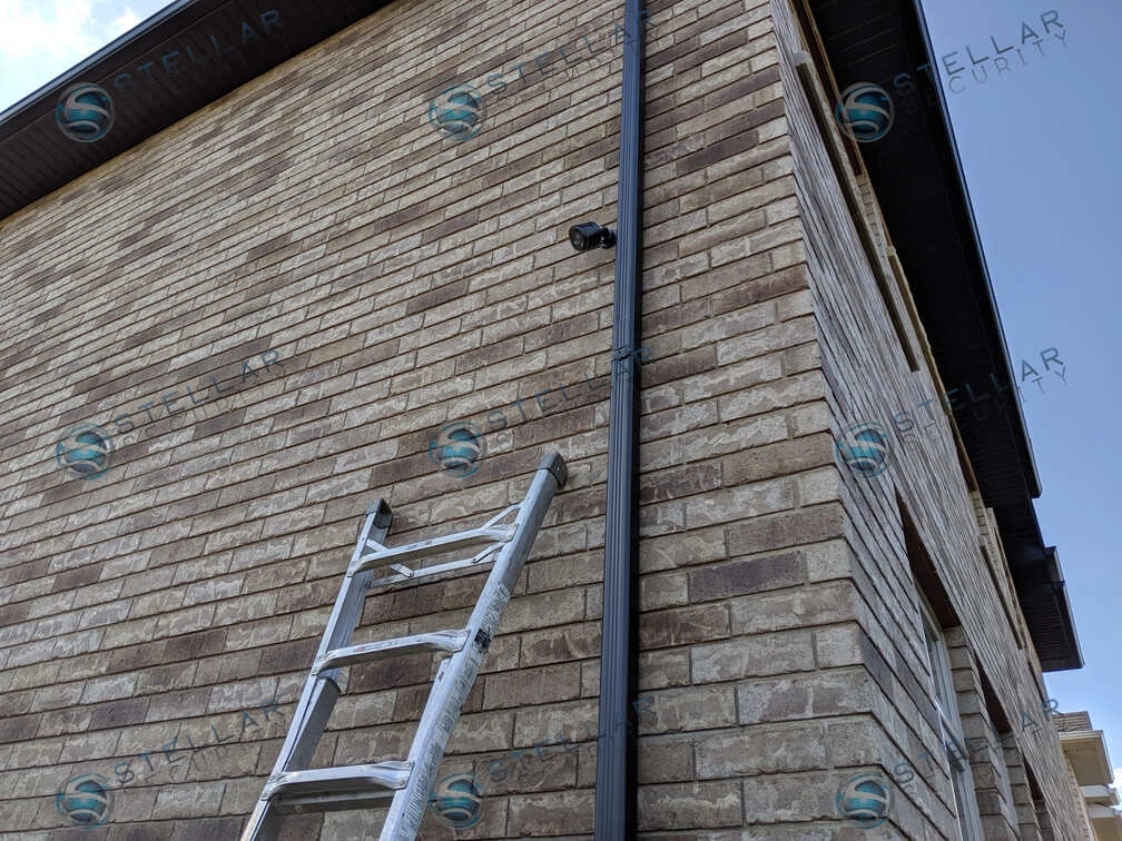 Security camera installed on side brick exterior wall of a Toronto residential home