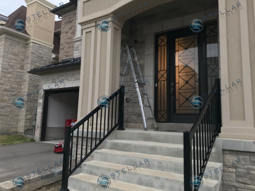 Wide view of front steps and stone pillar entrance with completed security camera installation in Vaughan