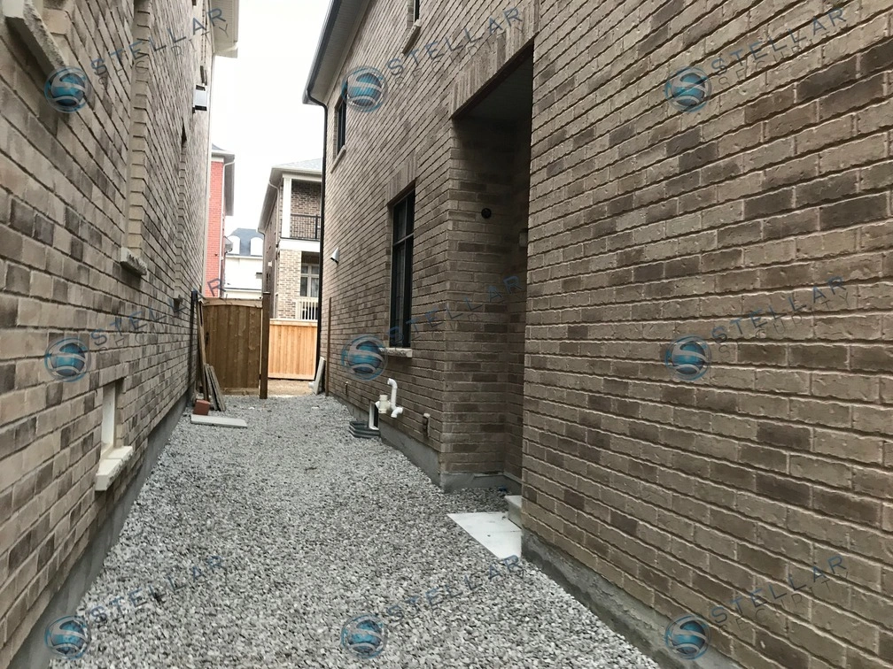 Side walkway alley view showing security camera coverage for a modern Vaughan home