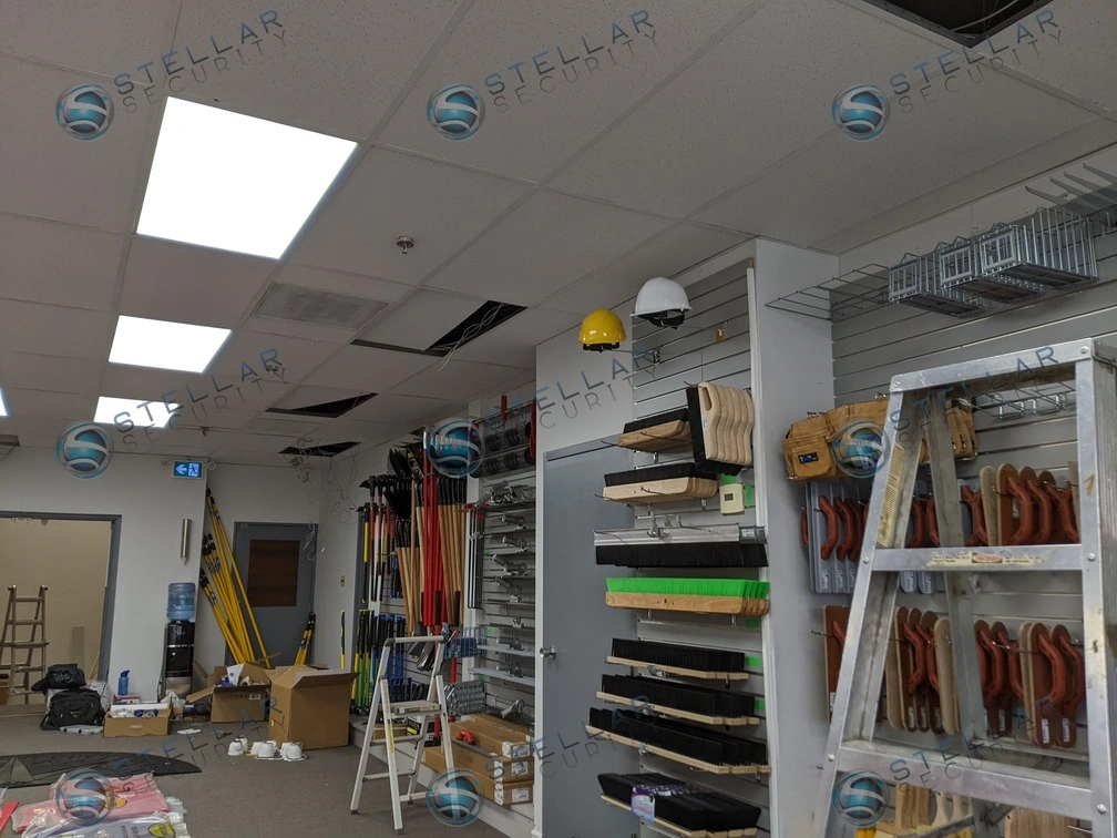 Indoor office drop ceiling featuring a sleek commercial surveillance camera installation.