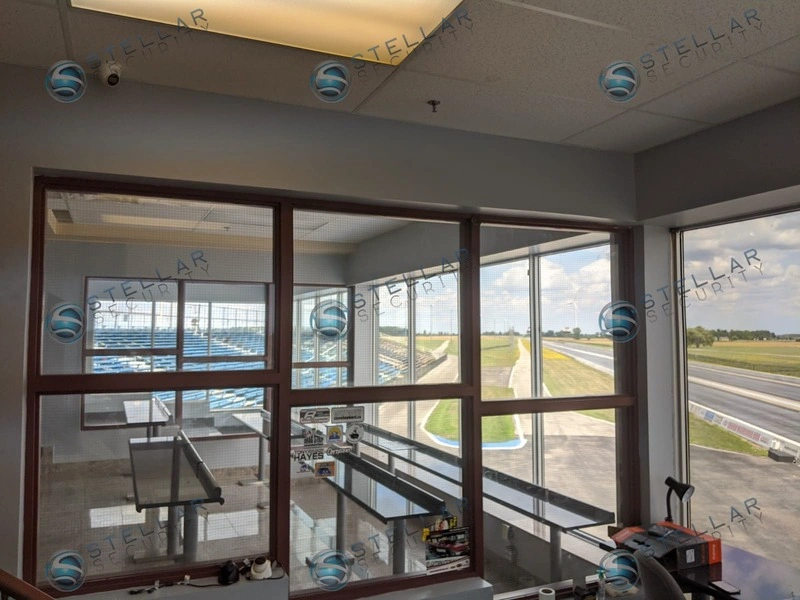 Unmounted security dome cameras on control room desk overlooking drag strip track layout.