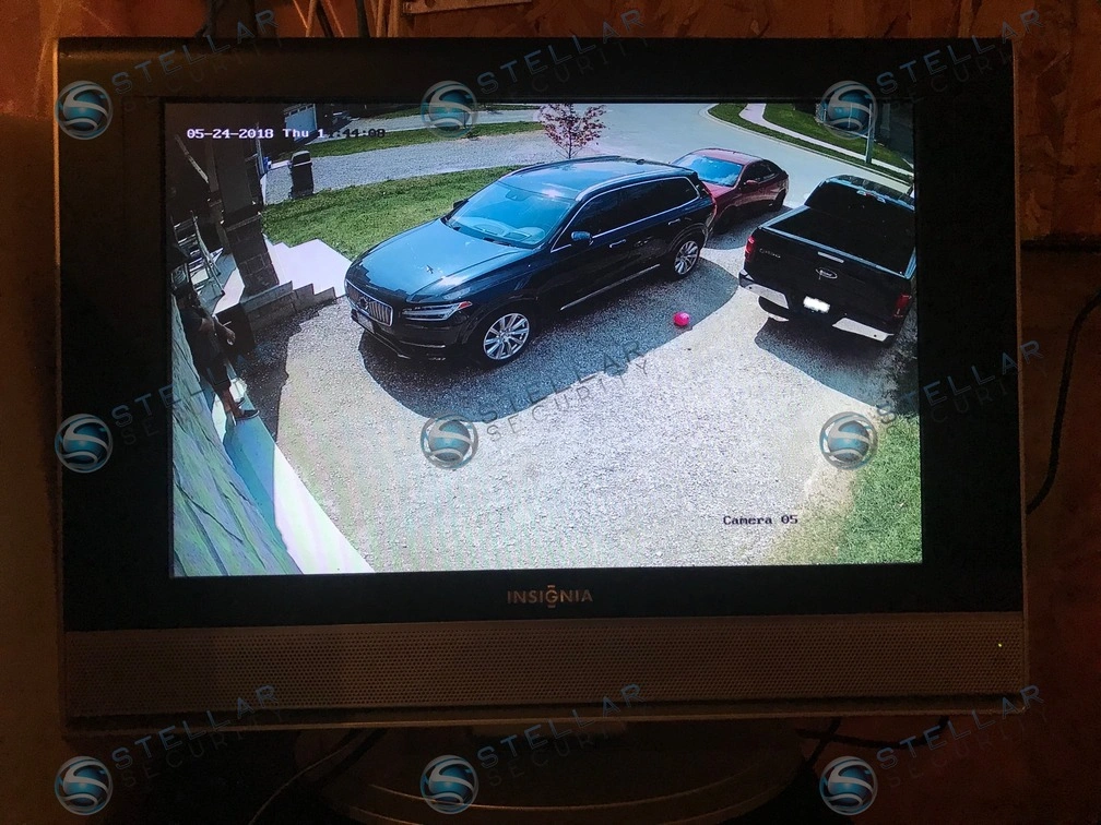 Live 4K security camera monitor feed showing broad view of driveway and parked cars in Hamilton