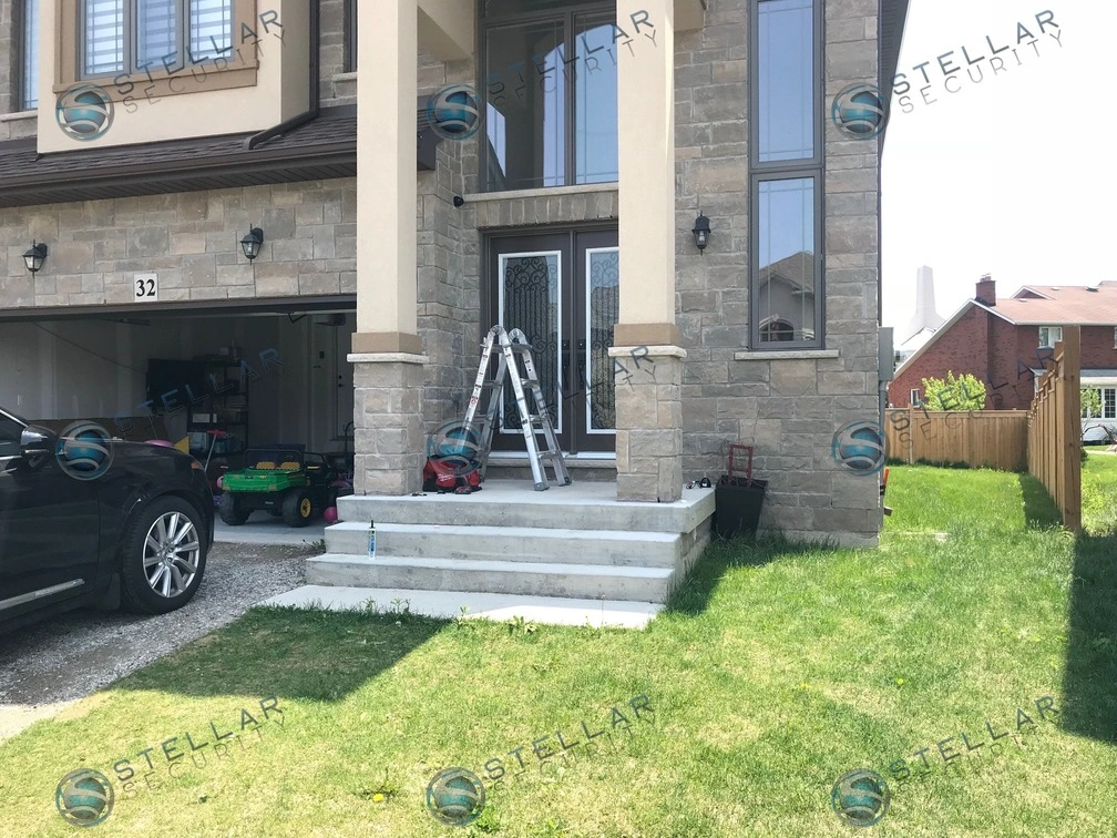 Full front view of stone residential property showing completed security camera layout in Hamilton