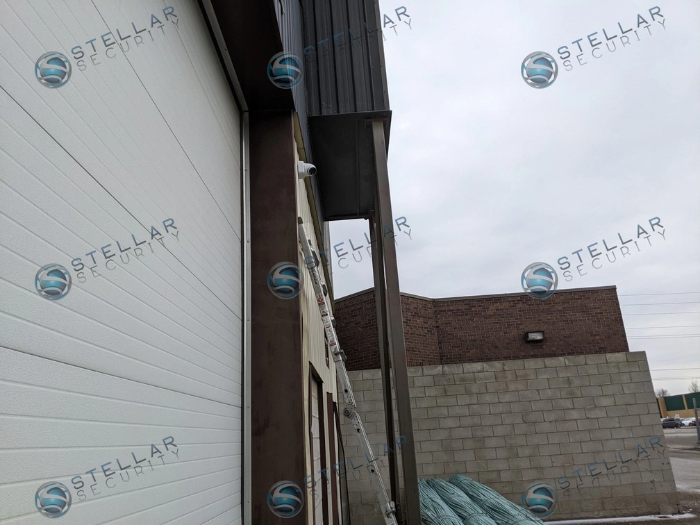 Metal siding warehouse exterior featuring perimeter security camera protection.