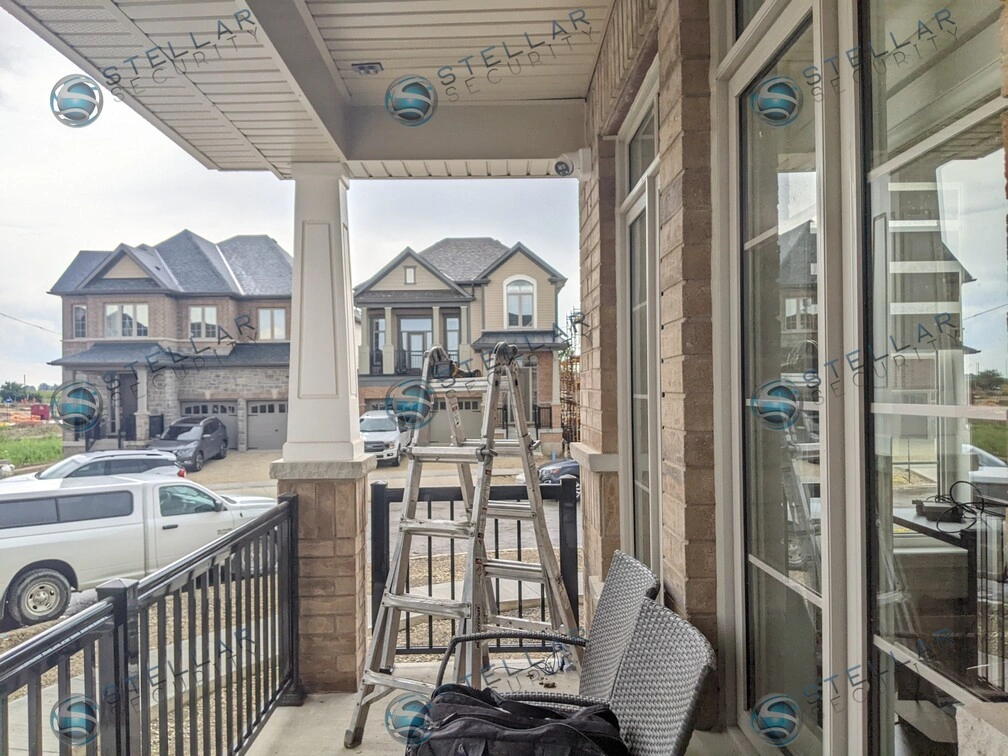 View from covered front porch showing setup for outdoor security camera mounting in Kitchene