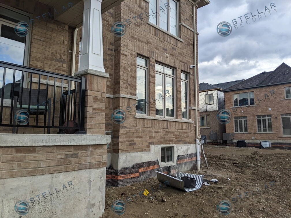 Side yard layout of new build brick home showing outdoor security camera placement in Kitchener