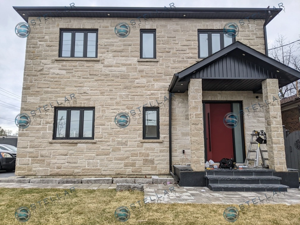 Modern two-story stone home in London featuring completed 4K security camera system installation