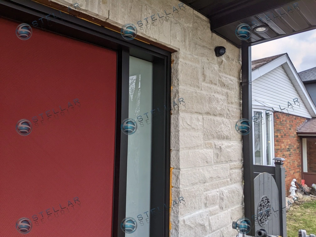 Angle view showing security camera placement protecting the red front door entrance of a London home