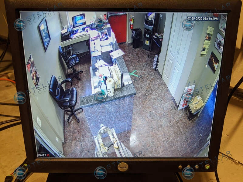 Overhead security camera monitor display covering race facility registration counter and lobby.